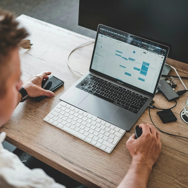 a freelance e-commerce project manager looking at his computer screen